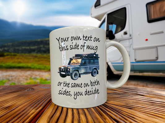 Mug with a graphic of a Land Rover and text on a wooden surface with an RV in the background