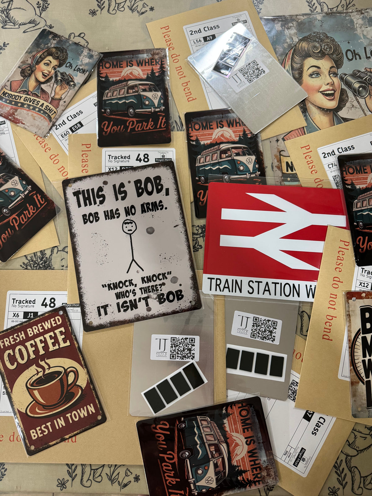 Collection of vintage-style signs and posters with text and graphics on a textured surface.