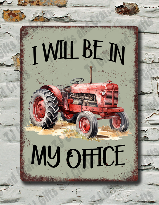A rectangular metal sign with a distressed vintage design, featuring a red tractor and the text 'I WILL BE IN MY OFFICE'. The sign is mounted on a white brick wall with peeling paint.