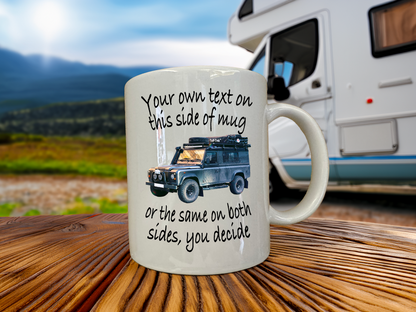 Mug with a graphic of a Land Rover and text on a wooden surface with an RV in the background
