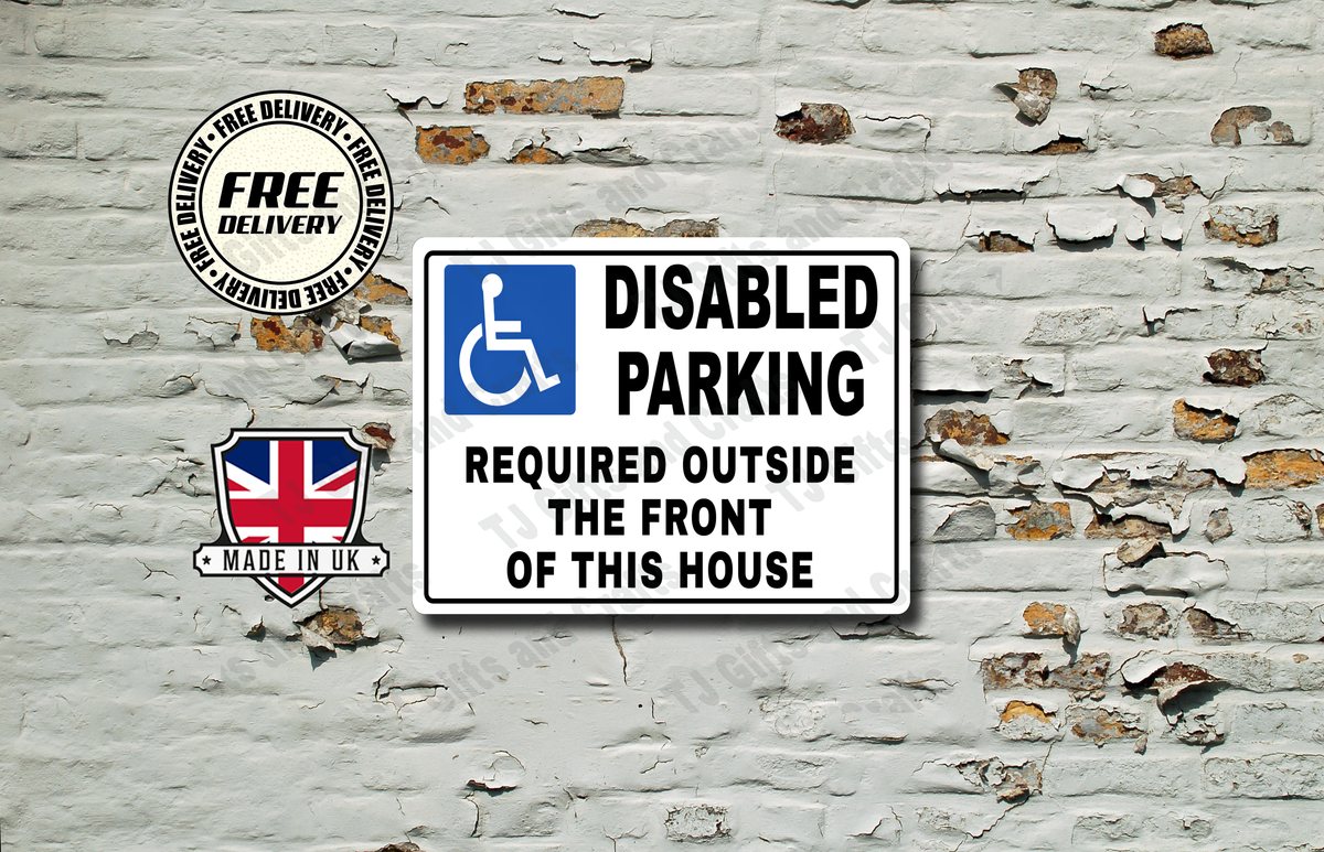 A rectangular white disabled parking sign with a blue handicap symbol and black text reading 'DISABLED PARKING REQUIRED OUTSIDE THE FRONT OF THIS HOUSE,' shown against a distressed white brick wall. A circular 'Free Delivery' badge and a 'Made in UK' shield graphic appear to the left.