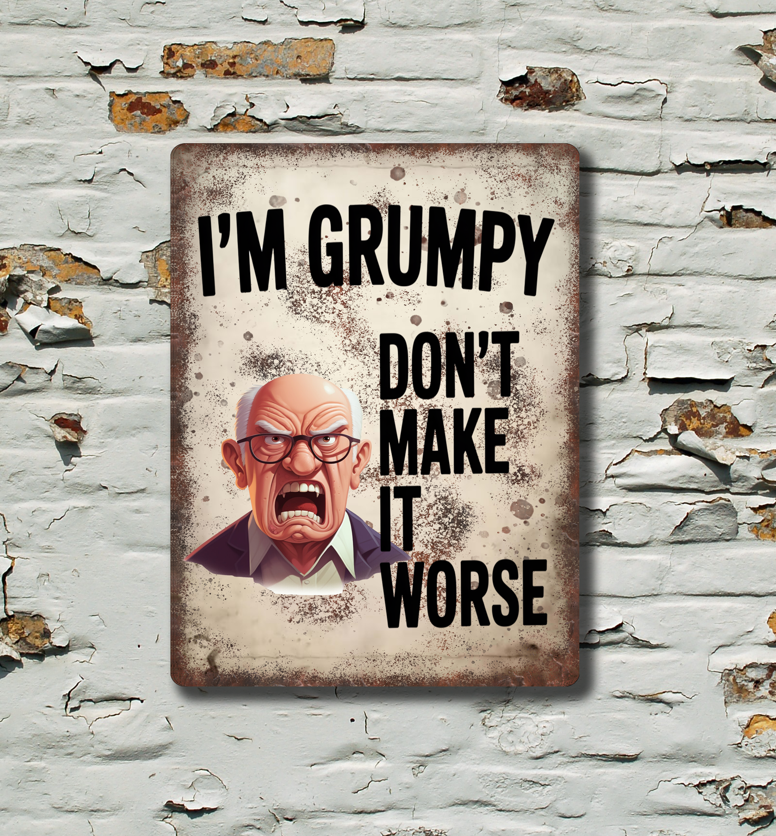 A rectangular metal tin sign with a distressed vintage look, featuring a grumpy cartoon man and the text 'I'M GRUMPY DON'T MAKE IT WORSE'. The sign is displayed on a white brick wall with peeling paint.
