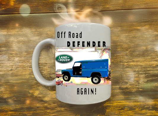 Mug with Land Rover Defender graphic and text on a wooden surface