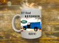 Mug with Land Rover Defender graphic and text on a wooden surface