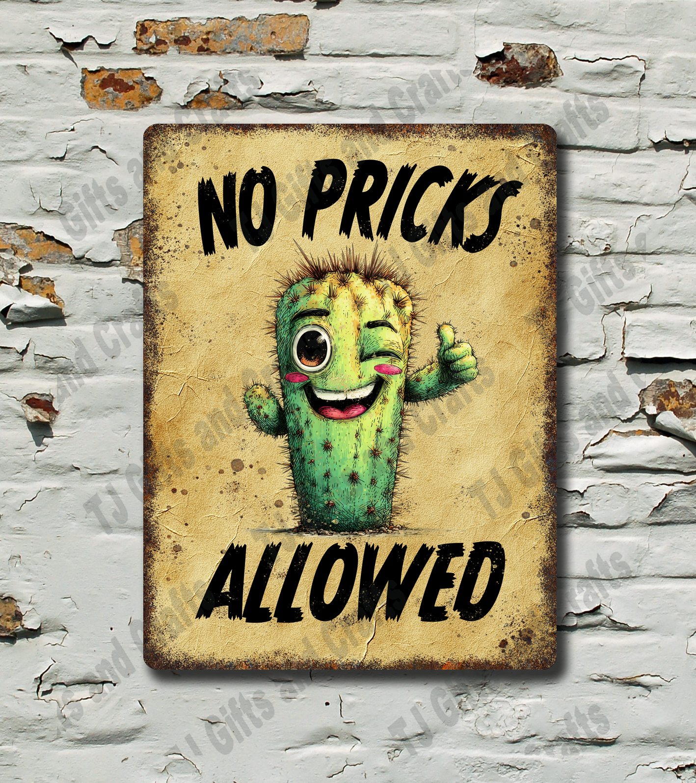 A rectangular vintage-style metal sign with a distressed beige background, featuring a winking green cactus and the text 'NO PRICKS ALLOWED' in black. The sign is mounted on a white brick wall with peeling paint.