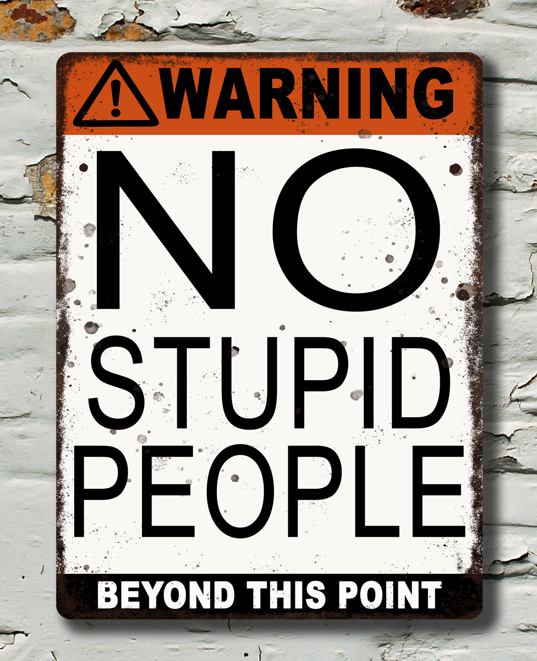 Warning sign no stupid people beyond this point on a brick wall