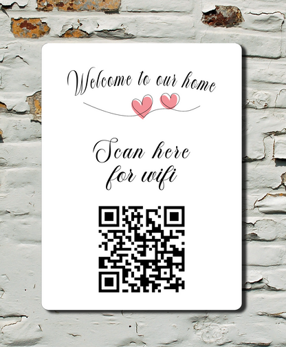 WiFi QR code sign on a textured wall with 'Welcome to our home' text