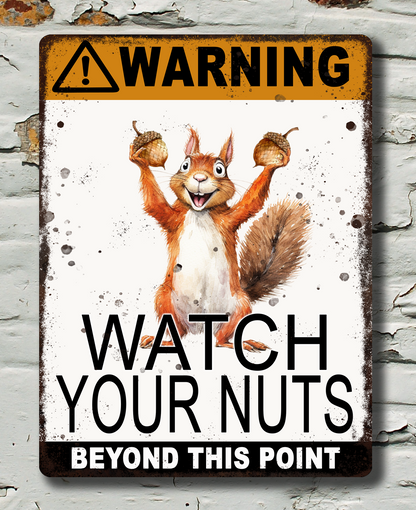 warning watch your nuts text on a metal sign with picture of squirrel holding 2 nuts