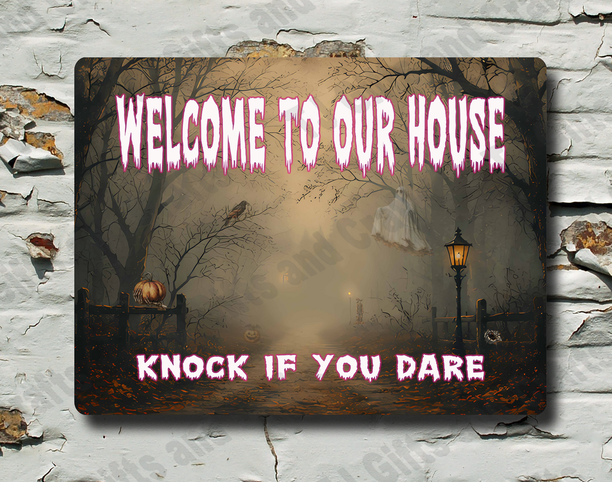 A rectangular Halloween wall sign with a spooky foggy forest scene and pink text reading 'WELCOME TO OUR HOUSE' and 'KNOCK IF YOU DARE', mounted on a distressed white brick wall.